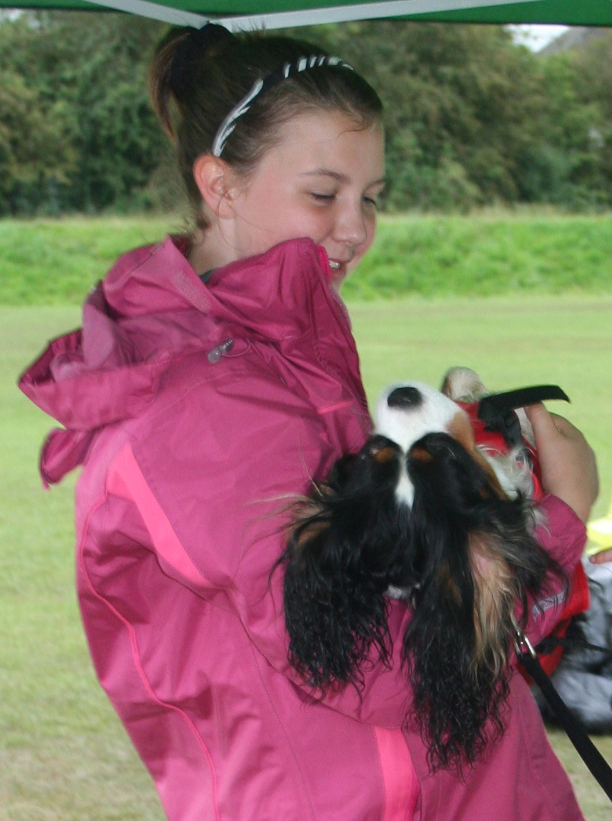 Teenager with dog in her arms